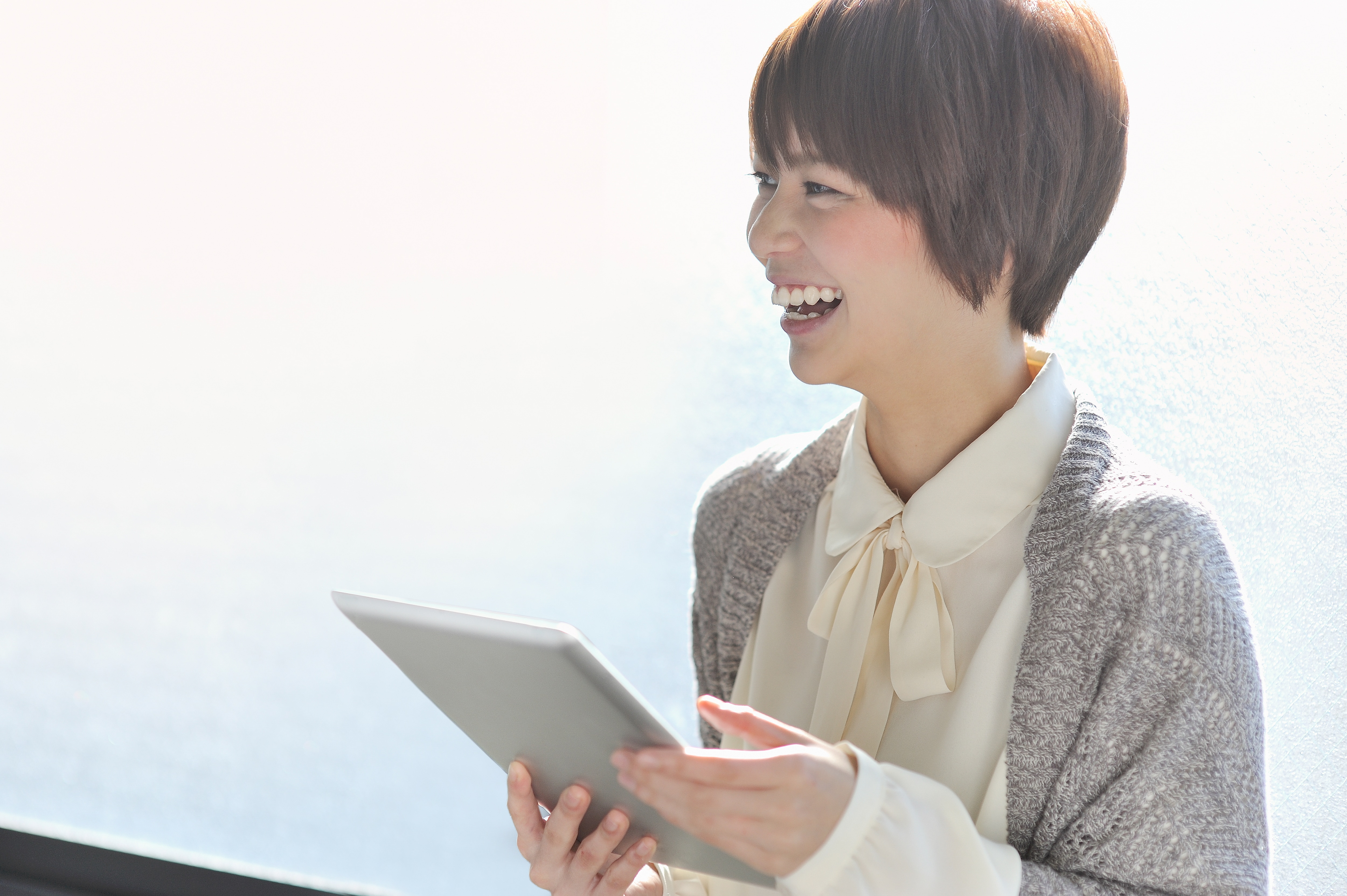 woman with a tablet smiling