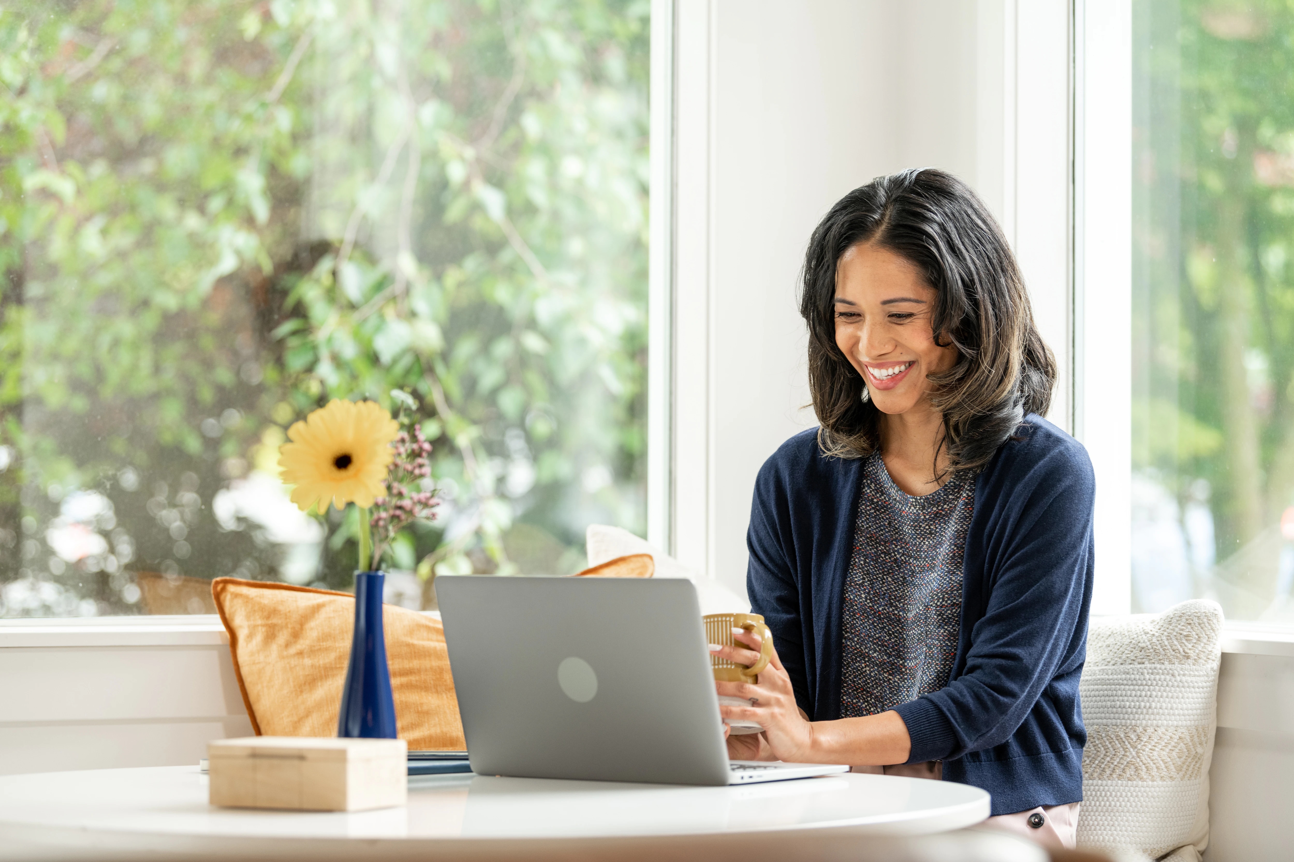 Smiling woman using laptop