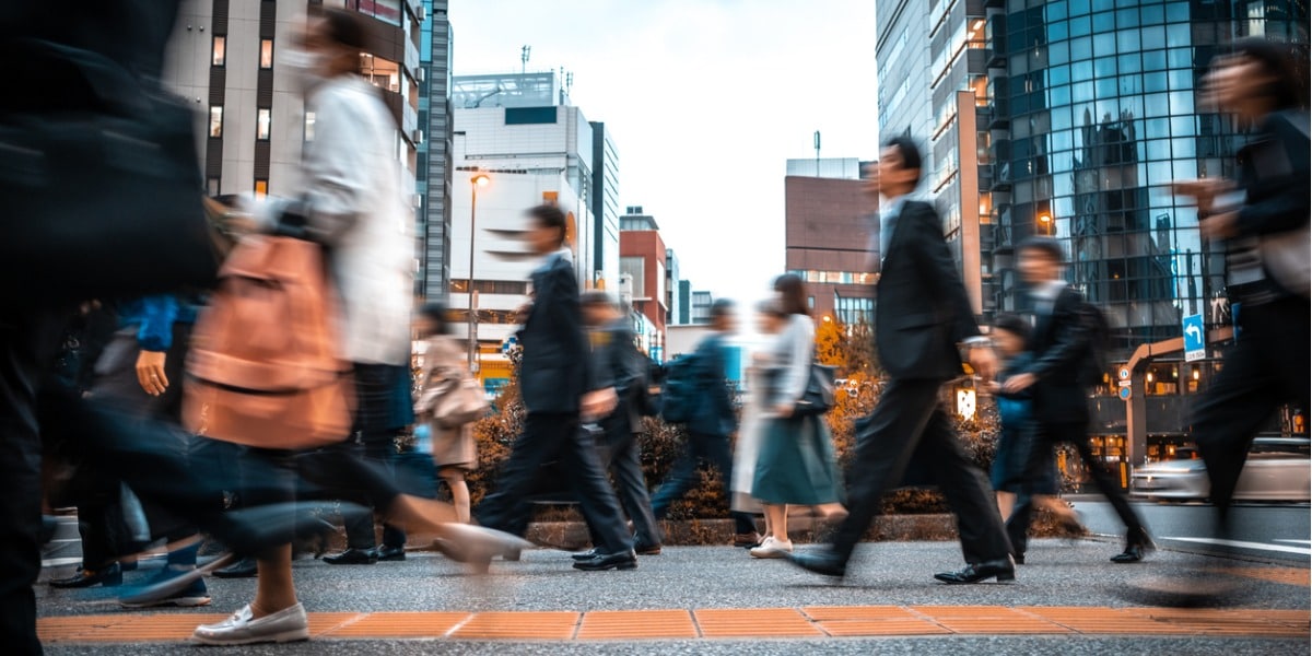 a blurred image of business people crossing the street