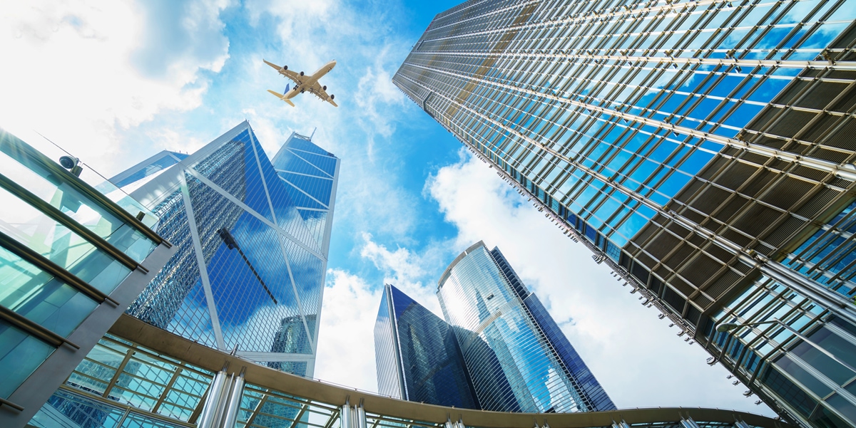 Skyscrapers and airplane in the sky