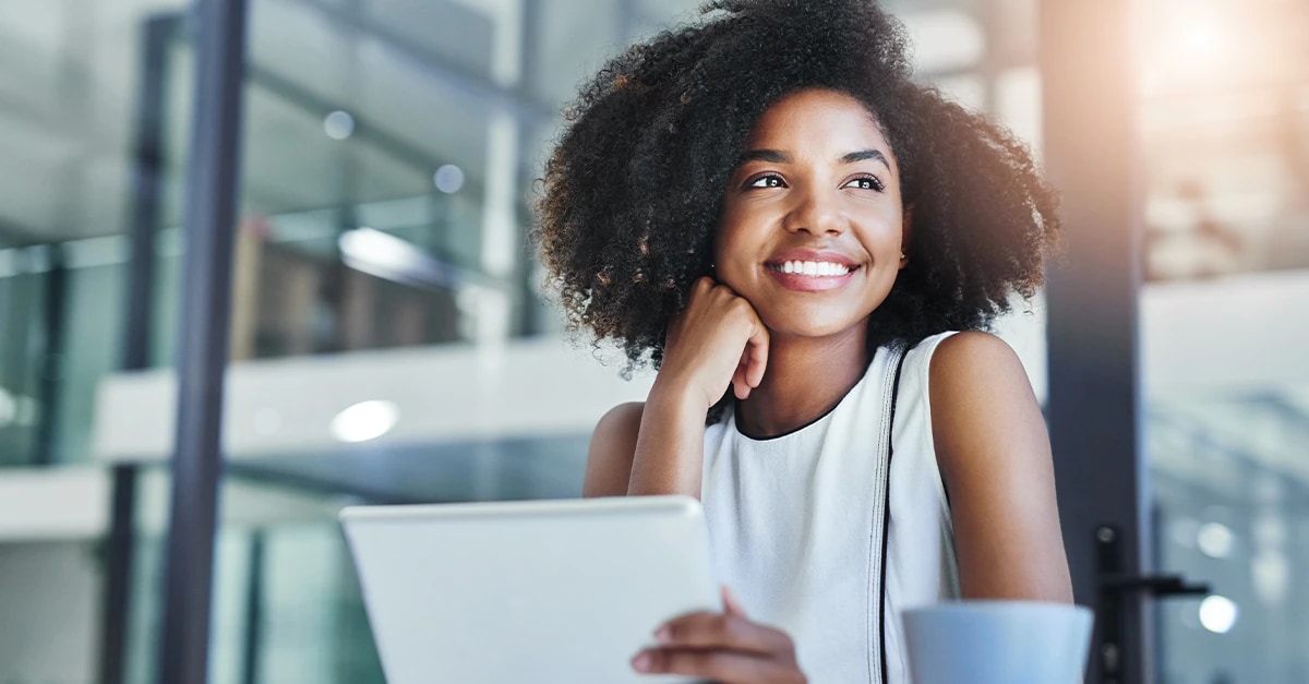 Smiling woman using tablet in an office