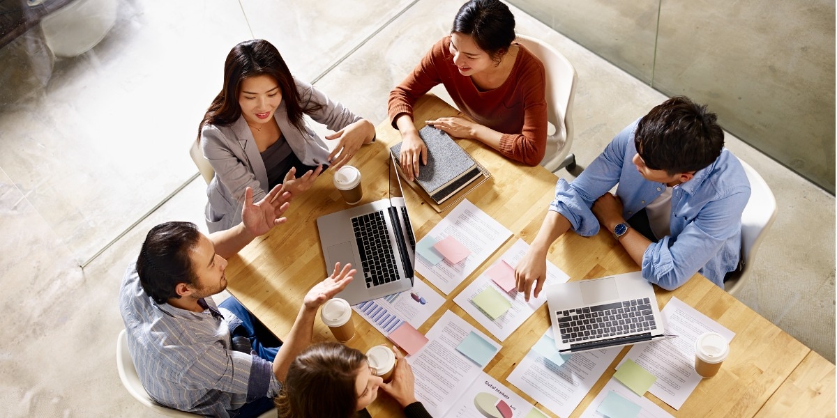 overhead view of a group of people having a meeting around a table