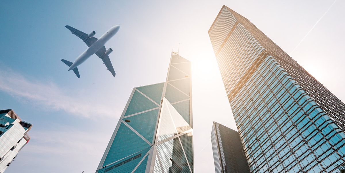 Skyscrapers and airplane in the sky