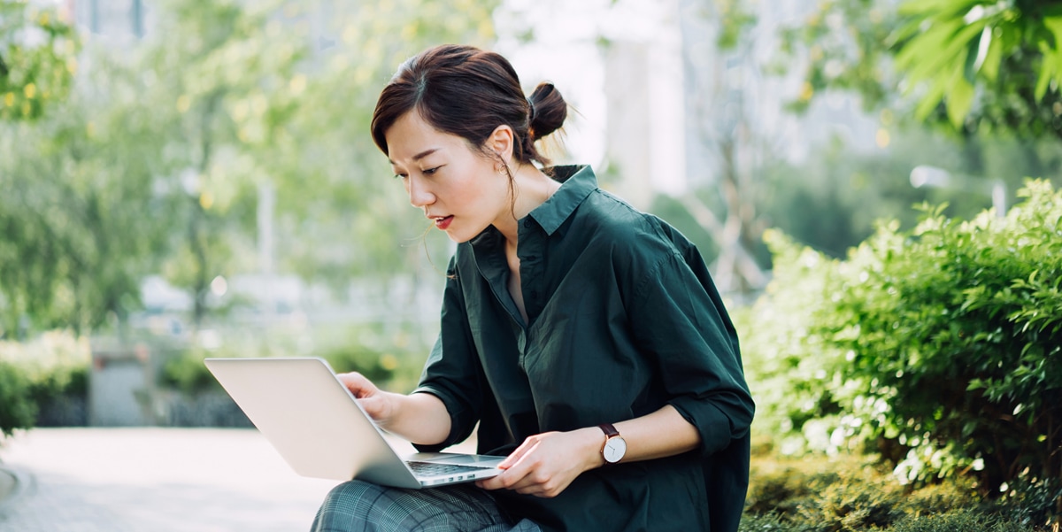 Woman sitting outside using her laptop