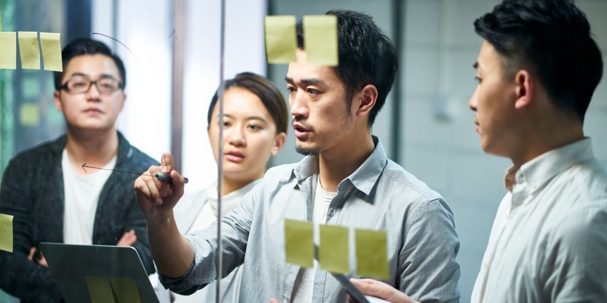 a group of people brainstorming with stickynotes